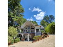 Stunning two-story home featuring a gable roof, expansive windows, and a welcoming front porch at 3645 Lake Bluff Dr, Sherrills Ford, NC 28763