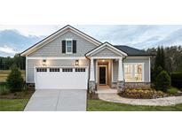 Charming single-Gathering home featuring a two-car garage and inviting stone and gray facade at 4138 Eastover Glen Rd # 0320, Charlotte, NC 28269