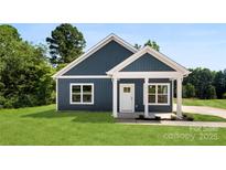 Charming blue home with white trim, well-manicured lawn, and inviting entrance at 1017 S Main St, Granite Quarry, NC 28146
