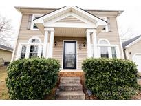 Charming covered front porch with sturdy columns and lush greenery enhancing curb appeal at 9232 Chislehurst Rd, Mint Hill, NC 28227