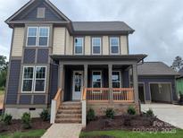 Charming two-story home featuring a welcoming front porch, a two-car garage and beautiful mixed siding at 239 Luray Way # 438, Rock Hill, SC 29730
