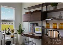 Bright home office featuring custom shelving, modern decor, and a large window at 2230 Endeavor Run, Charlotte, NC 28269