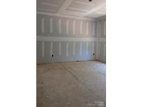 Unfinished living room featuring textured walls and ceilings, awaiting personalization at 120 Canary Ln # 6, Mooresville, NC 28115