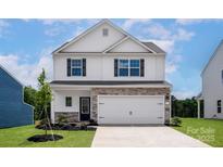 Charming two-story home with stone accents, attached garage, and lush green lawn at 7007 Jerimoth Dr, Charlotte, NC 28215