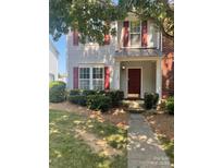 Charming home featuring red shutters, a covered porch, and a well-maintained front yard at 7125 Flying Scotsman Dr, Charlotte, NC 28213