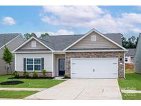 Charming single-story home with stone accents, a two-car garage, and a well-maintained lawn at 7319 Jerimoth Dr, Charlotte, NC 28215