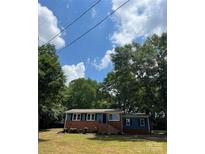 Charming blue and brick home with manicured landscaping and a lush green lawn at 1320 Kings Cir, Shelby, NC 28150