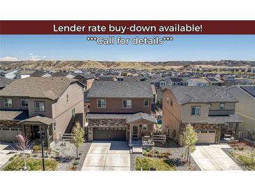 Charming two-story home with stone accents, a well-kept lawn, and a paved driveway in a Gathering-friendly neighborhood at 1914 Villageview Ln, Castle Rock, CO 80104