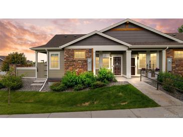 Charming single-story home with stone accents, landscaped front yard, and accessible ramp entrance at 12940 Jasmine St # A, Thornton, CO 80602