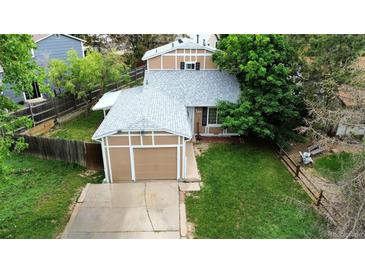 Aerial view of home with green lawn, newer roof and two car garage at 4677 S Salida St, Aurora, CO 80015