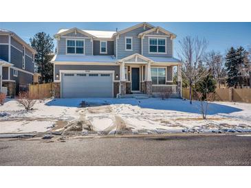 Charming two-story home featuring a two car garage and a cozy front porch perfect for enjoying neighborhood views at 9708 E Kansas Ave, Aurora, CO 80247