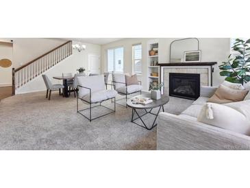 Bright living room features fireplace, shelving, modern furniture, and an adjacent dining area at 7367 S Pennsylvania St, Littleton, CO 80122