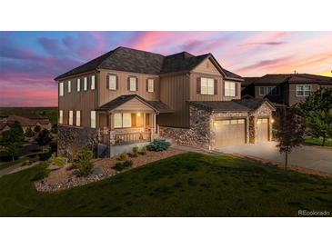 Beautiful two-story home with a three car garage and a covered porch at 7606 S Valleyhead Ct, Aurora, CO 80016