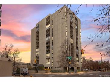 A tall building with symmetrical architecture rises with balconies and a crosswalk in front at 777 N Washington St # 304, Denver, CO 80203