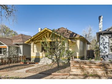 Charming bungalow with yellow accents, covered porch, and inviting curb appeal at 2421 Hooker St, Denver, CO 80211