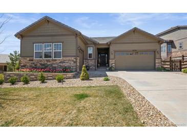 Beautiful single-Gathering home with manicured front yard, stone accents, and an attached two-car garage at 6705 S Catawba Way, Aurora, CO 80016