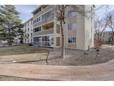 Low-rise apartment building features a well-maintained lawn and decorative concrete block facade at 3164 S Wheeling Way # 101, Aurora, CO 80014