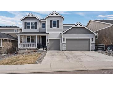 Charming two-story home with a well-manicured lawn and a two-car garage at 4792 Coltin Trl, Castle Rock, CO 80104