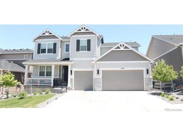 Charming two-story home with a two-car garage and a well-manicured front yard at 4792 Coltin Trl, Castle Rock, CO 80104