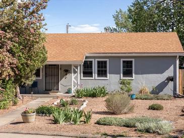 Charming single-story home featuring a well-kept landscaped yard with gravel, plants, and inviting curb appeal at 1568 S Osceola Way, Denver, CO 80219
