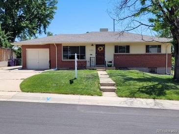 Charming single-story home featuring a brick facade, well-maintained lawn, and a welcoming front entrance at 2792 S Stuart St, Denver, CO 80236