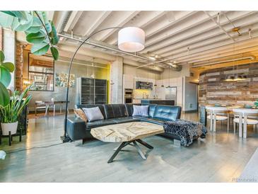 Bright living room boasts an open concept, modern decor, and an abundance of natural light at 2000 Arapahoe St # 305, Denver, CO 80205