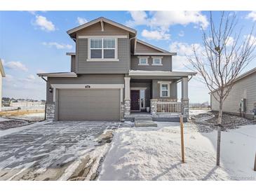 Two-story house with gray siding, attached garage, and snowy front yard at 996 Kolz Pt, Elizabeth, CO 80107