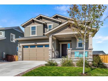 Charming two-story home featuring a covered porch, two-car garage, and well-maintained lawn at 1043 High Point Trl, Elizabeth, CO 80107