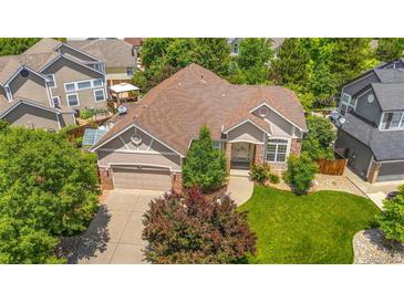 Inviting exterior view of a single-Gathering home with a well-manicured lawn and mature trees at 3494 S Otis Ct, Lakewood, CO 80227