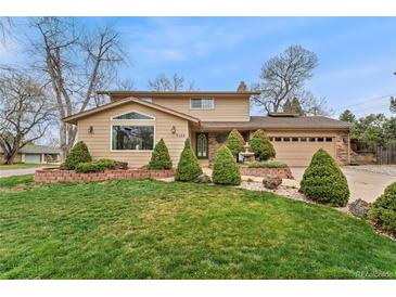 Charming two-story home featuring a manicured front yard and a classic architectural design at 7106 S Kendall Blvd, Littleton, CO 80128