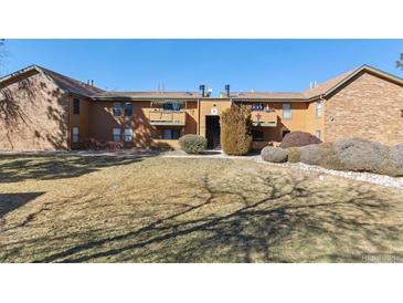 Well-maintained brown apartments with landscaping and brown trim at 3335 S Ammons St # 103, Lakewood, CO 80227