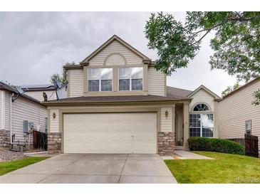 Charming two-story home featuring a neutral color scheme, an attached two-car garage and stone accents at 2792 S Ceylon St, Aurora, CO 80013