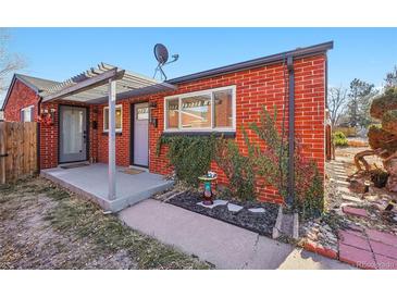 Brick ranch home with covered patio, landscaping, and a pergola at 3324 N Glencoe St, Denver, CO 80207