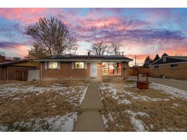 Brick ranch home with solar panels and well-manicured lawn at 1441 E 84Th Pl, Denver, CO 80229