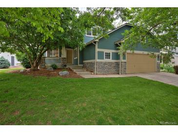 Charming two-story home with a well-maintained front yard and a cozy covered porch at 2500 Lexington St, Lafayette, CO 80026