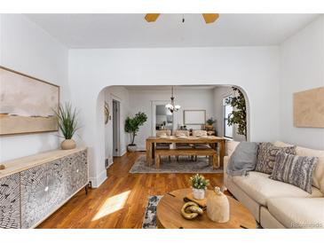 Inviting living room and dining room area features hardwood floors, tasteful decor, and plenty of natural light at 4518 Vallejo St, Denver, CO 80211