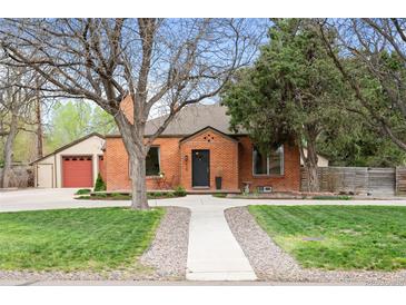 Charming brick home with a well-manicured lawn and mature trees in a desirable neighborhood at 435 Balsam St, Lakewood, CO 80226