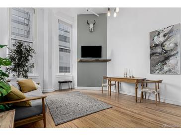 Inviting living room featuring hardwood floors, stylish decor, and large windows offering ample natural light at 720 16Th St # 311, Denver, CO 80202