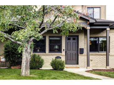 Charming brick home featuring a well-manicured lawn and freshly painted door and trim at 1272 S Milwaukee St, Denver, CO 80210