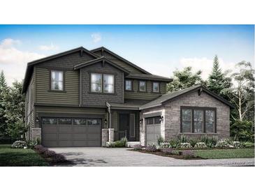 Two-story home featuring stone and vertical siding, a two-car garage, and a welcoming entrance at 2914 S Poppy St, Morrison, CO 80465