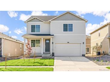 Inviting two-story home featuring a covered porch, well-maintained lawn, and an attached two-car garage at 3347 Belleville Ridge Rd, Elizabeth, CO 80107