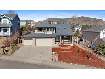 Charming two-story home boasts a brick and siding exterior, two-car garage, and landscaped front yard at 1304 5Th St, Golden, CO 80403