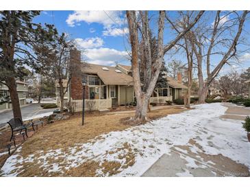 Charming two-story home with manicured front lawn, mature trees, and inviting entrance during the winter at 2003 S Helena St # D, Aurora, CO 80013