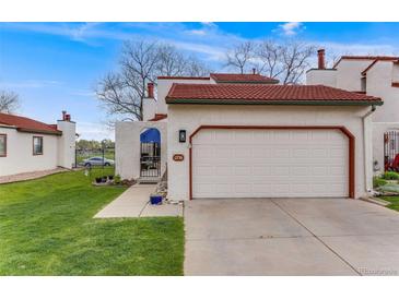 Charming home featuring a red tile roof, two car garage and landscaped front yard at 1236 Sequerra St, Broomfield, CO 80020