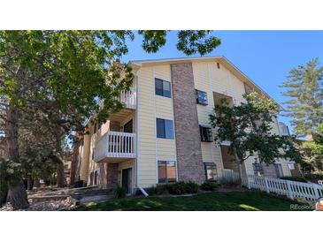 Multi-level condo building with brick accents, balconies, and well-maintained landscaping at 12506 E Cornell Ave # 201, Aurora, CO 80014