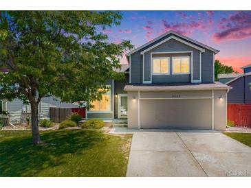 Charming two-story home featuring a well-maintained lawn and an attached two-car garage at 4422 E Andover Ave, Castle Rock, CO 80104