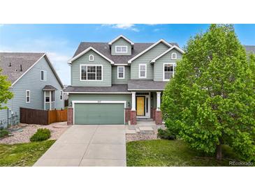 Charming two-story home boasts a well-manicured lawn, inviting curb appeal, and an attached two-car garage at 3717 Desert Ridge Cir, Castle Rock, CO 80108