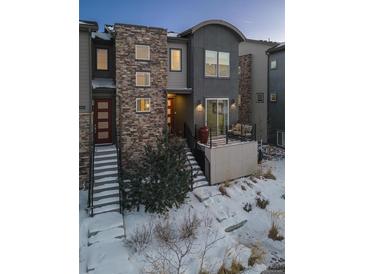 Modern three-story townhome with stone accents and private deck at 2584 Meadows Blvd # E, Castle Rock, CO 80109