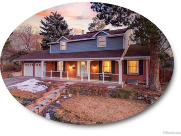 Charming two-story home with a welcoming front porch and well-manicured landscaping at 6721 S Clayton Way, Centennial, CO 80122