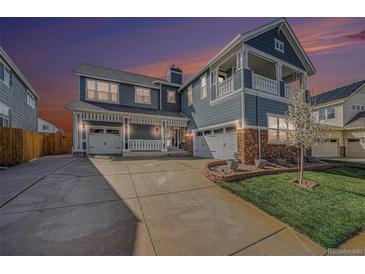 Beautiful two-story home with a well-manicured lawn, covered porch, and a spacious driveway at 4073 S Liverpool St, Aurora, CO 80013